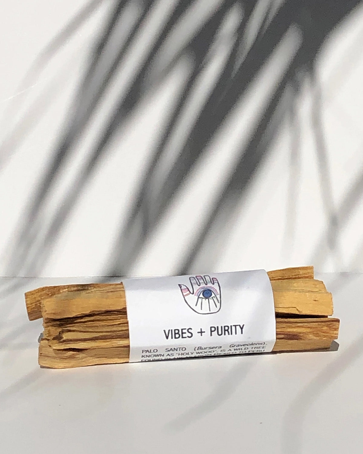 Wooden incense sticks with a white label on a light background
