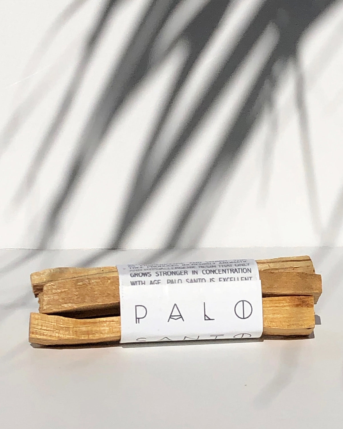 Palo Santo sticks wrapped in paper with 'Palo' branding on a white background
