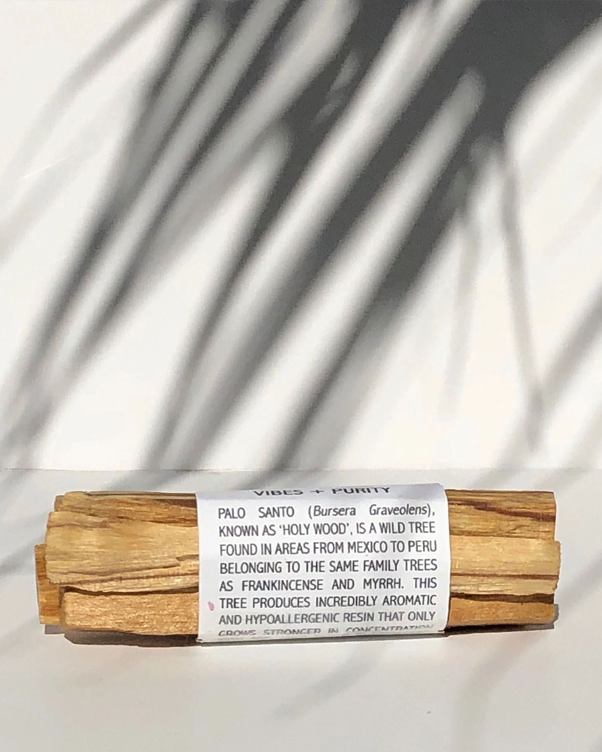 Palo Santo sticks wrapped in paper with text on a white background