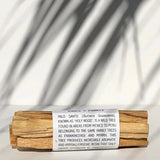 Palo Santo sticks wrapped in paper with text on a white background