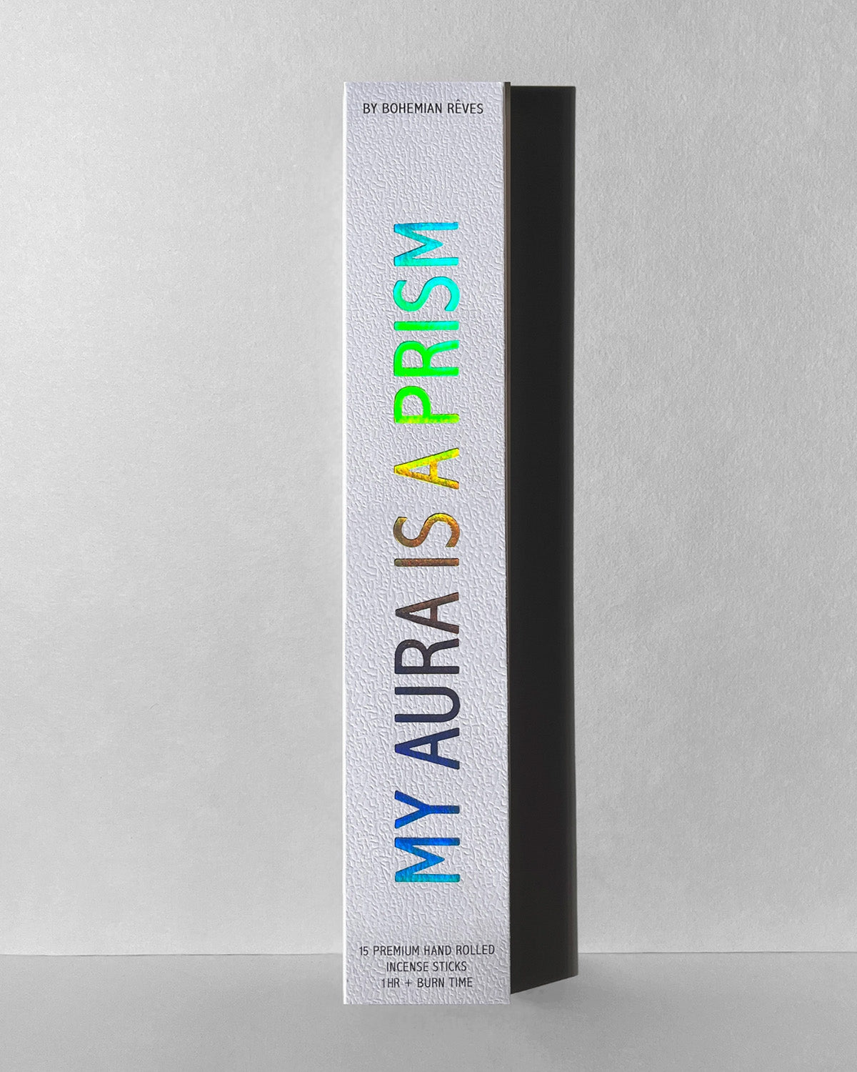 Product packaging with 'My Aura is a Prism' text on a gray background