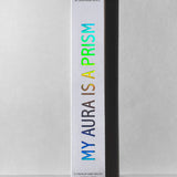Product packaging with 'My Aura is a Prism' text on a gray background