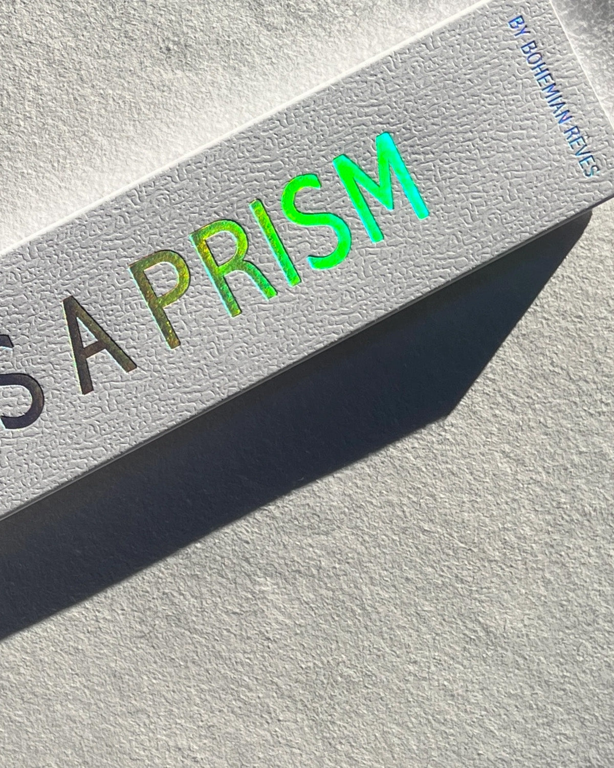 Product packaging with 'PRISM' text in green on a textured surface