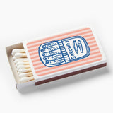Matchbox with striped design and 'Sardines' label on a white background