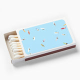 Matchbox with a blue cover featuring illustrations of people in swimsuits on a white background