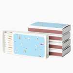 Stack of books with a blue and pink cover design on a white background