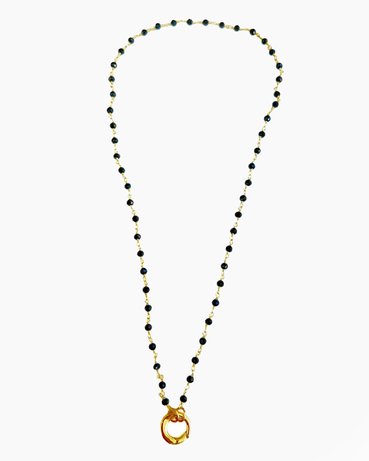 Necklace with black beads and a gold clasp on a white background