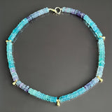 Necklace with blue beads on a dark gray background