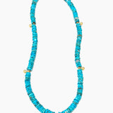 Turquoise beaded necklace with gold accents on a white background