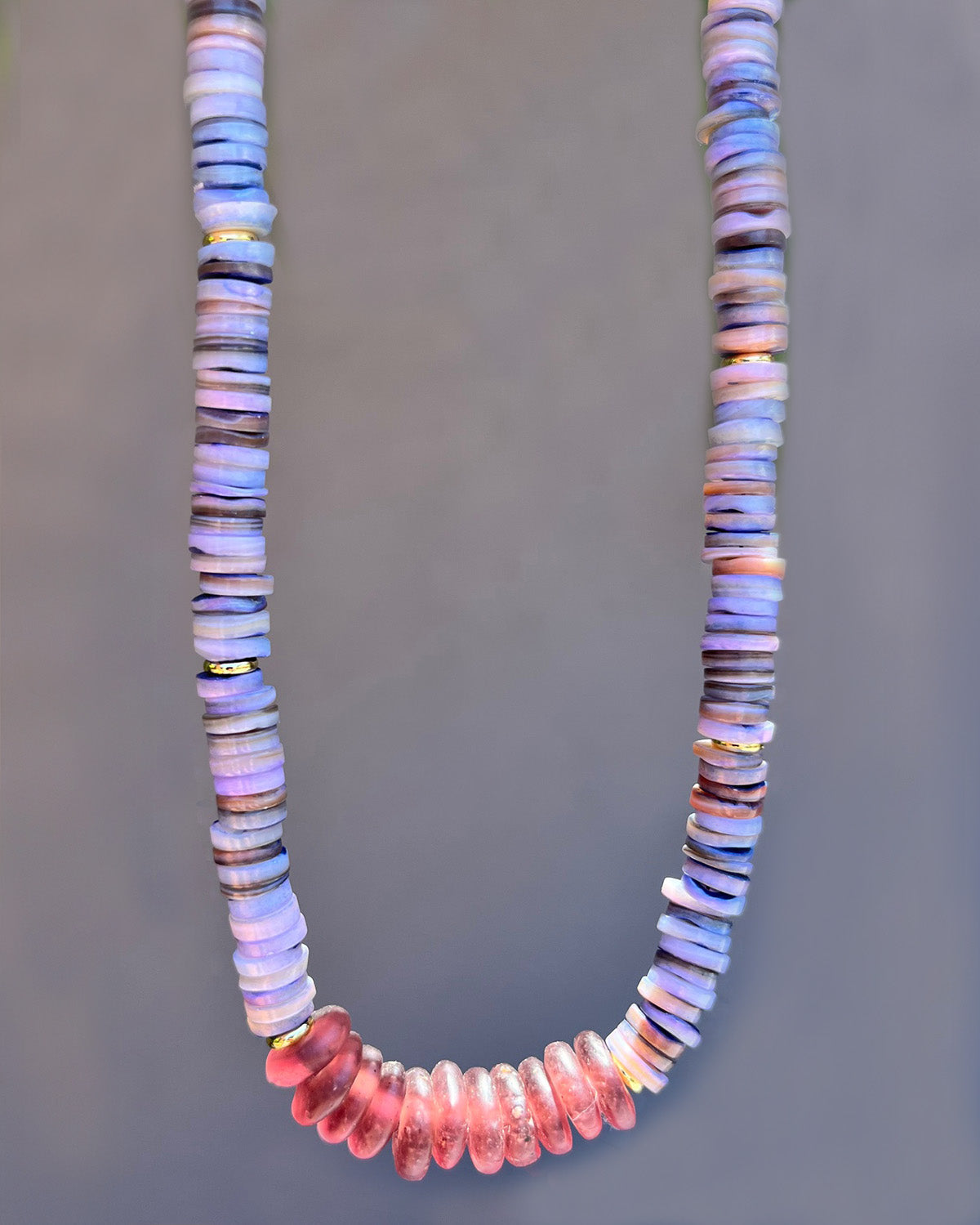 Necklace with multicolored beads on a gray background
