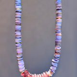 Necklace with multicolored beads on a gray background