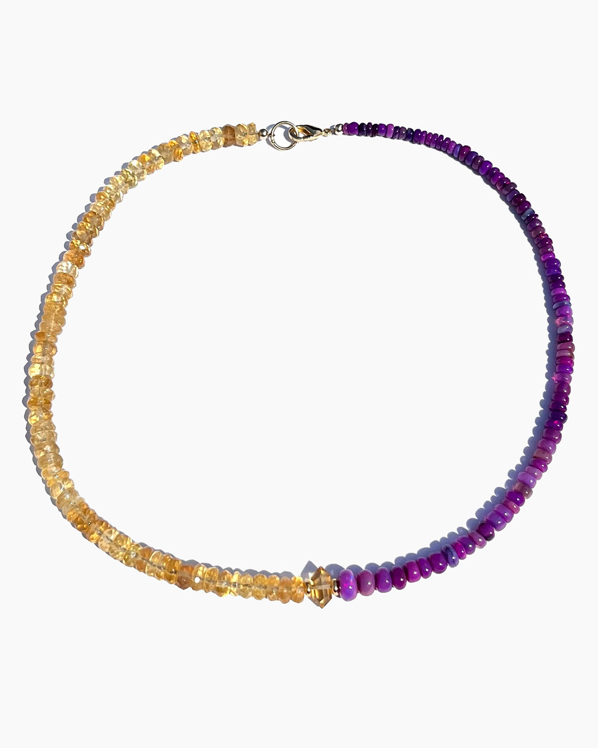 Necklace with alternating yellow and purple beads on a white background