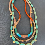 Multicolored beaded necklace on a dark textured surface