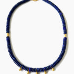 Blue beaded necklace with gold accents on a white background