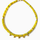 Yellow beaded necklace on a white background