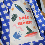 Drawstring bag with colorful graphics and text on a blue and white checkered background