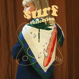Person wearing a colorful scarf with 'surf collection' text overlay
