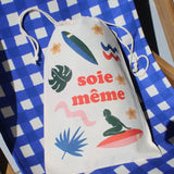 Drawstring bag with colorful graphics and text on a blue checkered background