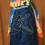 Person wearing a colorful jacket with 'surf collection' text and artistic design on an orange background