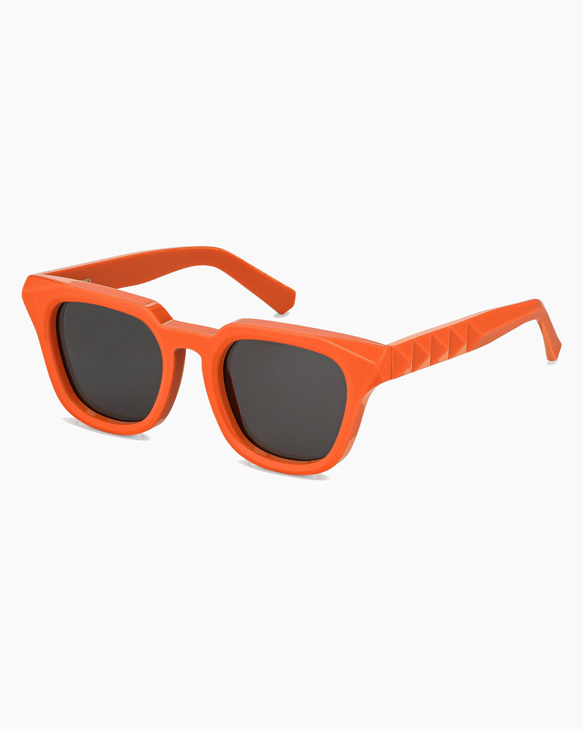 Orange sunglasses with dark lenses on a white background