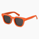 Orange sunglasses with dark lenses on a white background