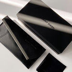 Black Saint Owen wallet and cardholder set on a light gray background