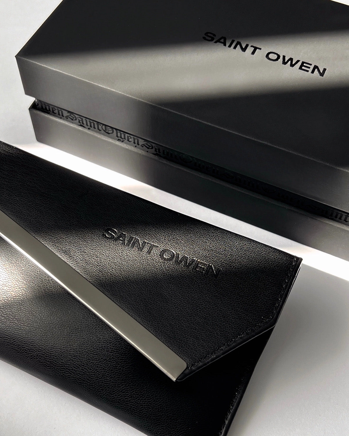 Black leather wallet with 'SAINT OWEN' branding on a white background