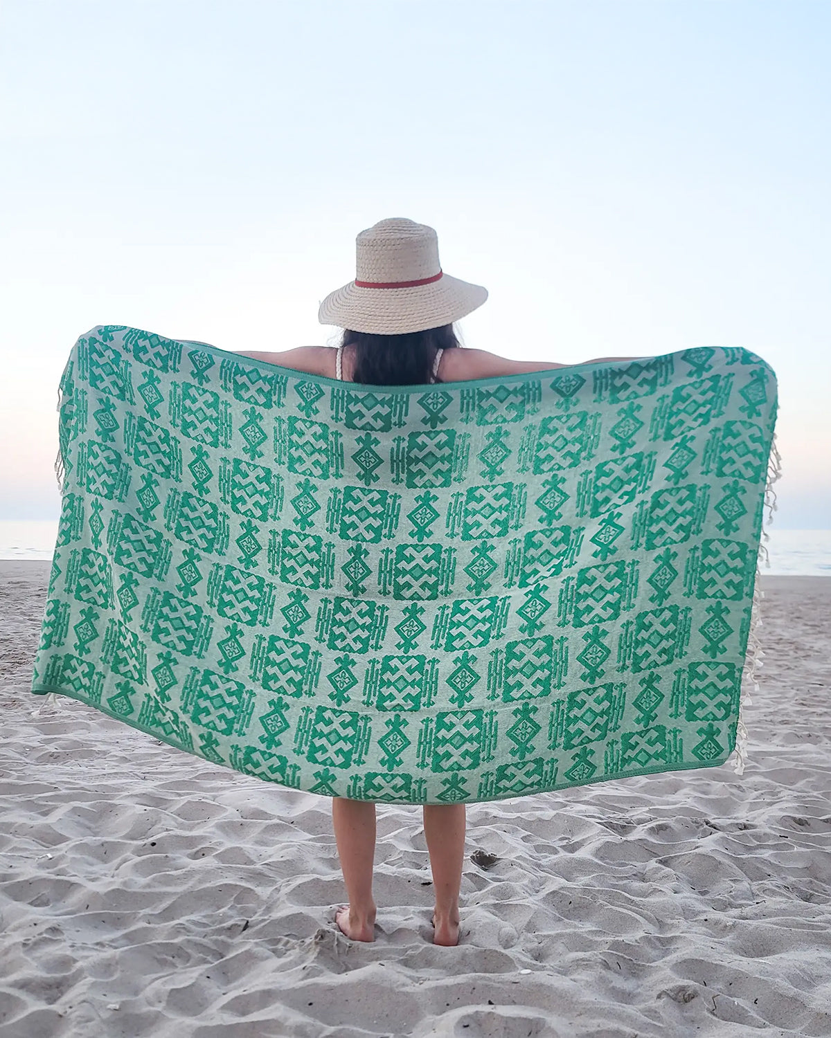Girl holding green geometric Turkish towel