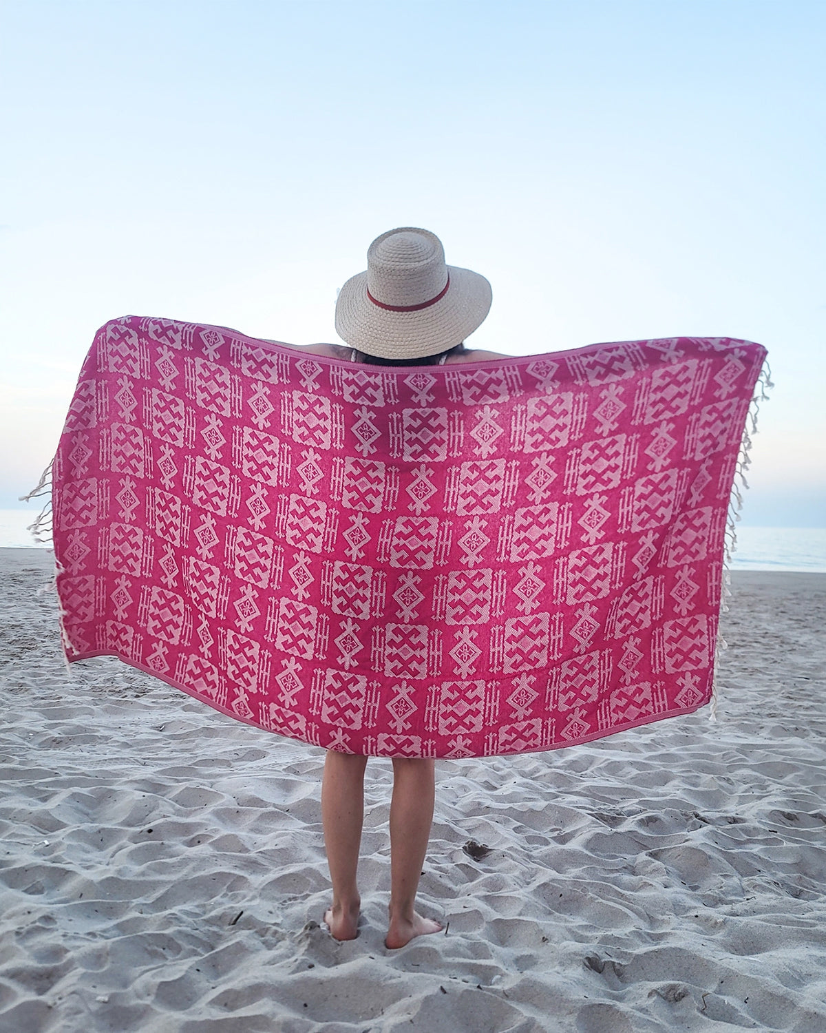 Girl holding pink geometric Turkish towel
