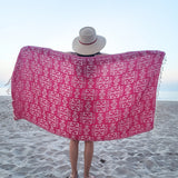 Girl holding pink geometric Turkish towel
