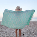 Girl holding turquoise geometric Turkish towel